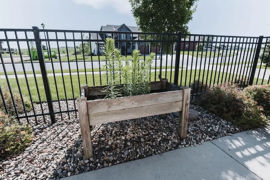 Raised planter inside the fenced courtyard at Oakwood Senior Living